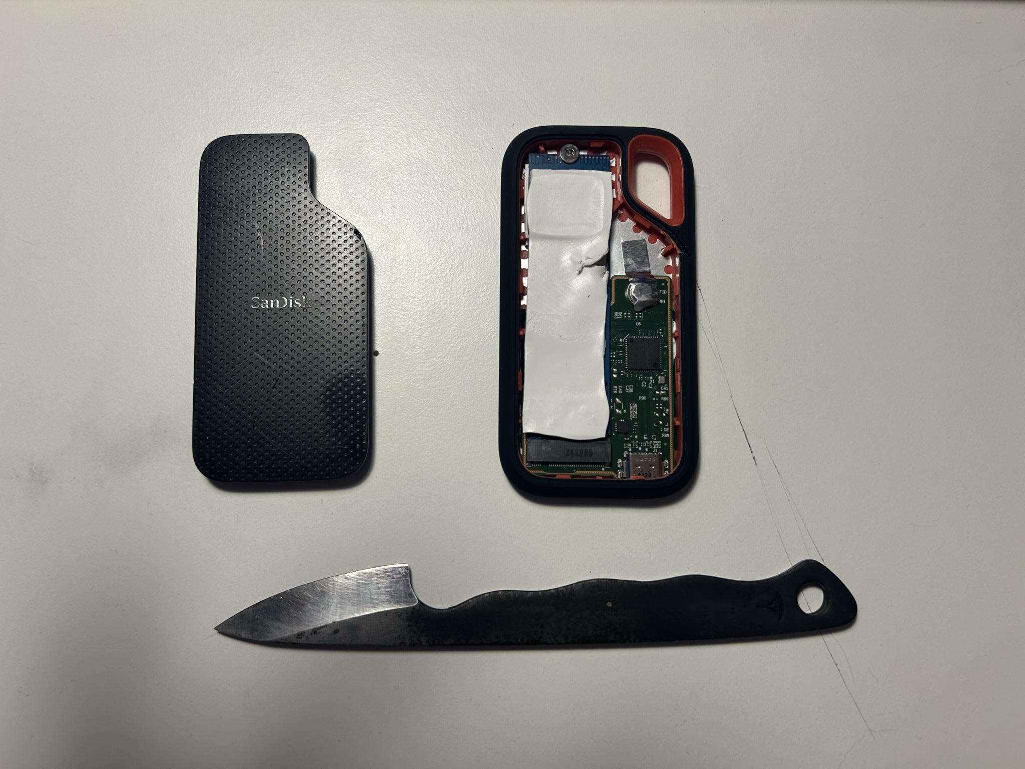 Front cap removed. Knife, cap, and the controller + M.2 assembly with thermal paste still in place.