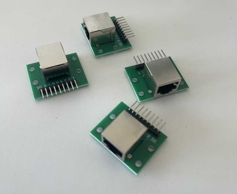 Four RJ45 breakout boards, two 220 pF ceramic caps, and a mini breadboard. €15 worth of parts.